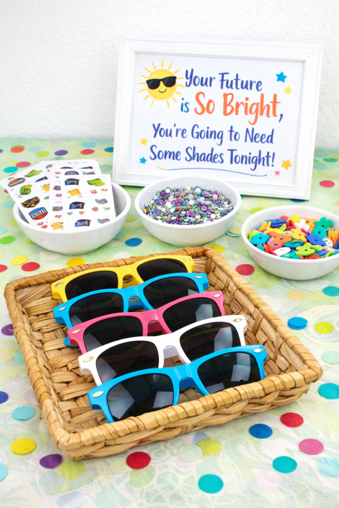 kids decorating sunglasses with paint pens and rhinestones craft activity